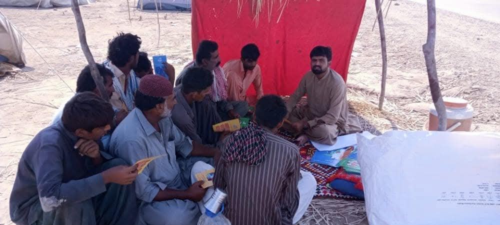 Community meeting held under a tent