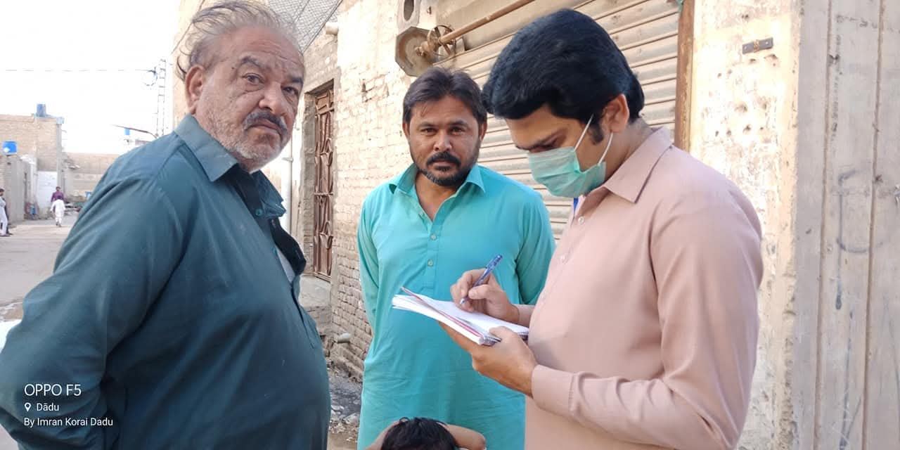 Volunteers recording household details during a survey