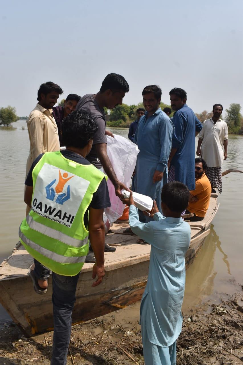Family receiving ration bag during flood relief