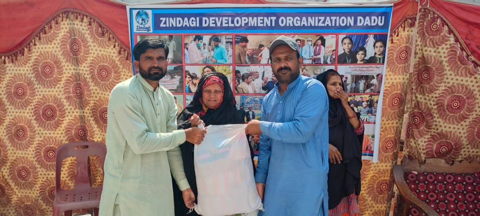 Ration bag being handed to an elderly beneficiary at the ZDO office