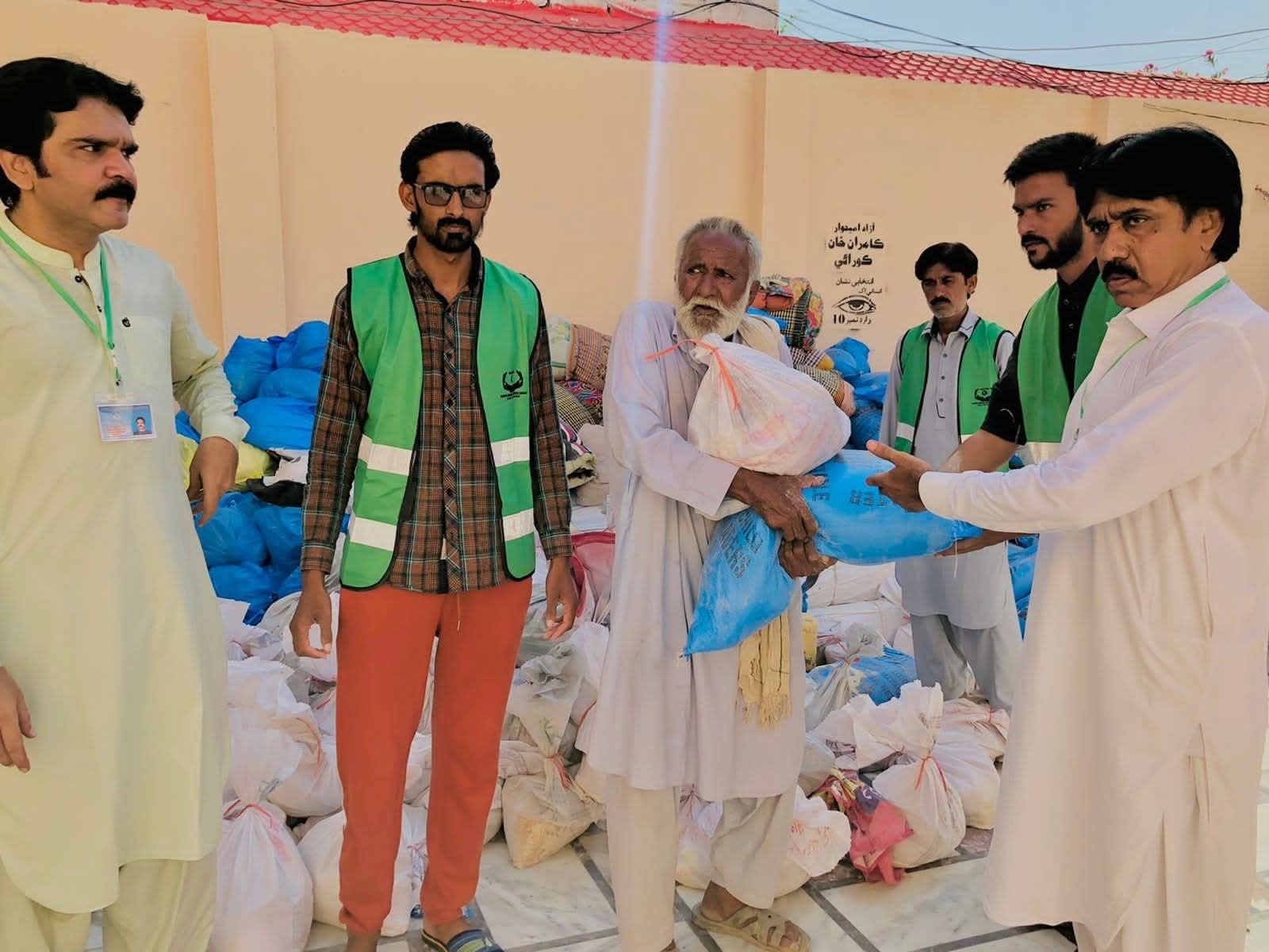 An elderly beneficiary receiving his ration package
