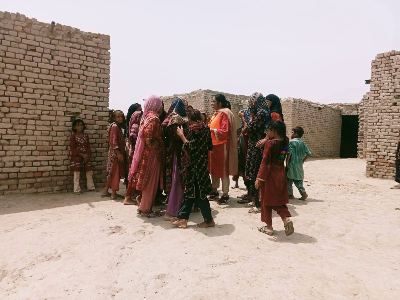 Women and children walking through their village